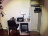 a small desk with a microwave and a small refrigerator