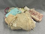 many bags of fabric and cloth on a gray surface