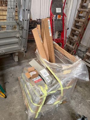 a pile of cardboard sitting on top of a pallet in a warehouse