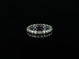 a close up of a silver ring on a black surface