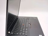a black laptop with a red button on the keyboard