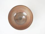 a brown bowl on a white table with a white background