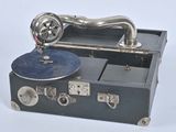 an old record player sitting on top of a suitcase