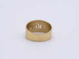 a close up of a gold ring on a white surface