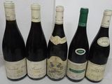 six bottles of wine are lined up in a row on a table