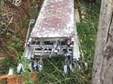 a metal cart that is sitting in the grass