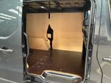 a man standing in the back of a van with the door open