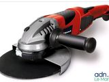 a close up of a red and black polisher on a white surface
