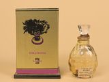 l'image d'un flacon de parfum posé à côté d'une boîte