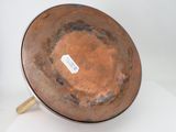 a brown bowl sitting on top of a white table