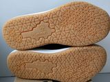 a close up of a pair of shoes on top of a cardboard box