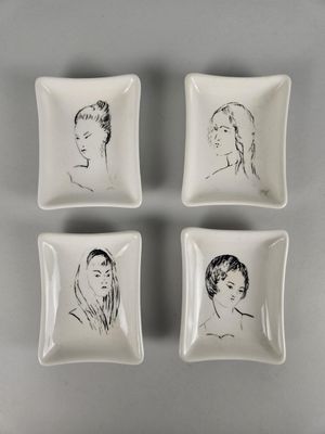 four square dishes with black and white drawings of women on them