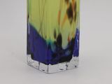 a glass vase with a blue and yellow liquid inside of it