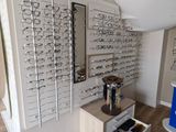 many glasses on the wall in the store