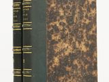 two books sitting on top of each other on a white surface