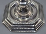an antique silver plated candle holder sitting on a table