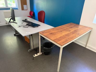 un bureau sur lequel se trouve un ordinateur, dans une pièce aux murs bleus