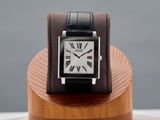 a watch that is sitting on top of a wooden stand