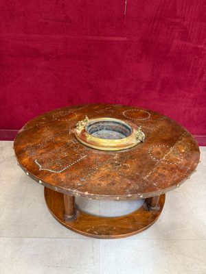 a wooden table with a metal bowl on it
