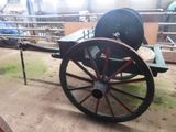 a horse drawn carriage that is sitting on the ground
