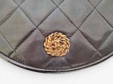 a black purse with a gold flower on it