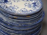 a stack of blue and white plates stacked on top of each other
