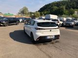 many cars parked in a parking lot with trees in the background