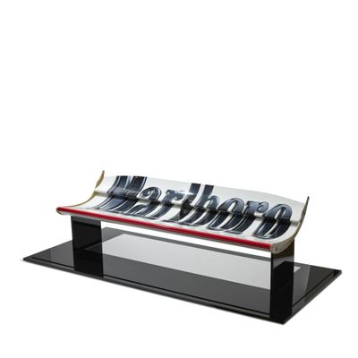 an image of a glass bench with metal letters on it