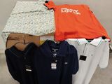 a lot of clothes on a table in a room