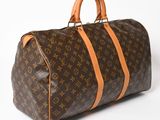 a brown and tan louis vuitton bag on a white surface