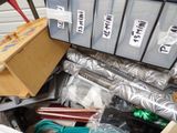 a pile of assorted items in a bin on the floor