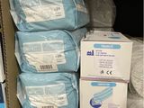 many packages of disposable face masks in a box