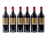 six bottles of red wine are lined up on a white surface