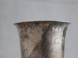 a silver vase sitting on top of a table
