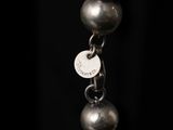 an image of a close up of a necklace on a black background