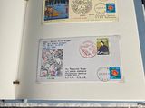 an open book with stamps on it sitting on a table