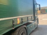 a green truck that is parked in the parking lot