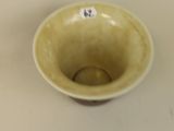 a small yellow bowl with a sticker on it