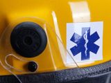 a sticker on the back of a helmet with a medical symbol on it