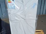 a white refrigerator sitting on a pallet in front of a building
