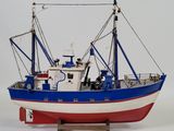 a model of a boat on a stand on a white surface