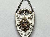 a close up of a metal badge with a chain around it