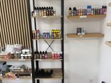 a shelf that has many bottles of paint on it