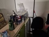 a desk with a computer and a chair in a room