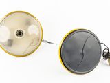pair of yellow and black lamps on a white surface with a white background