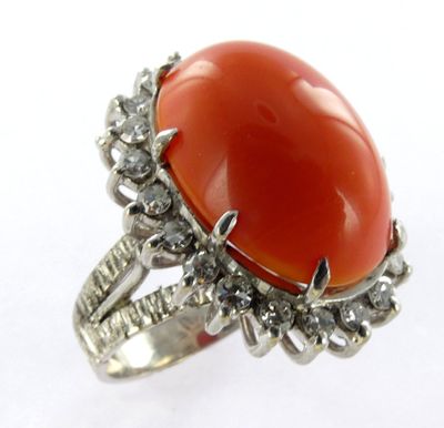 a close up of a ring with a red stone on it