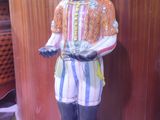 a statue of a boy standing on a box