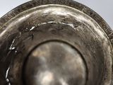 a close up of a metal bowl with writing on it