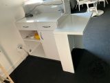 a small kitchen with a white counter and white cabinets