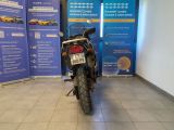 a motorcycle that is parked in front of a blue banner